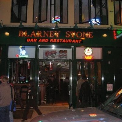 Exterior view of Blarney Stone Bar and Restaurant with neon signage.