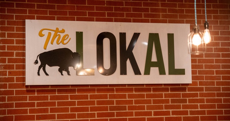 Business logo sign on the exposed brick wall