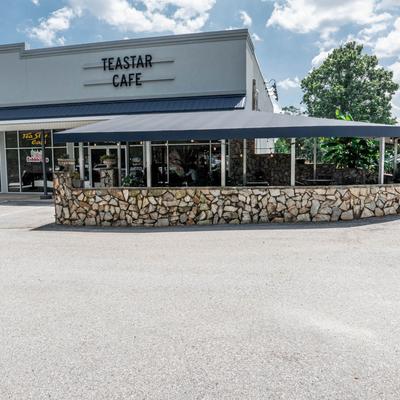Exterior with signage and outdoor seating.