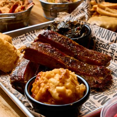 Barbecue ribs served with mac and cheese, cornbread and greens.