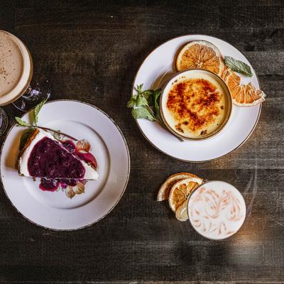 Cheesecake, Creme Brulee, and a cocktail, top view.