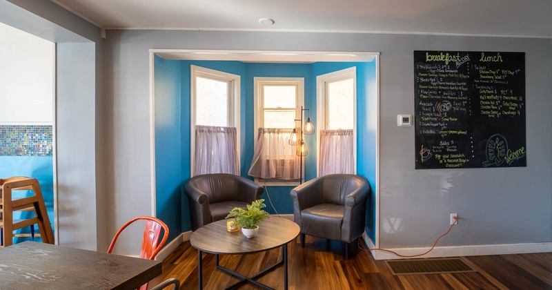 Armchairs and coffee table, chalkboard menu on the wall