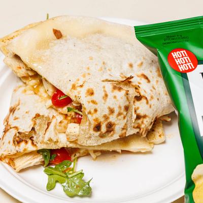 Otisco Panuozzi with chicken, cheese, arugula, hot honey, and cherry tomatoes.