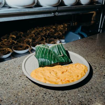 Creamy omelet served with a banana leaf wrap.