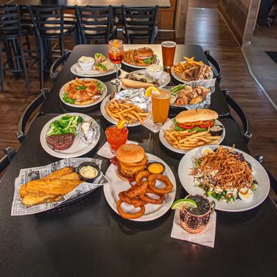 Assortment of menu items served on the table with various drinks.
