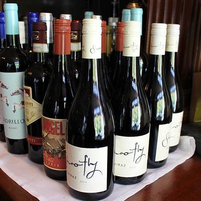 Assorted wine bottles arranged on a shelf.