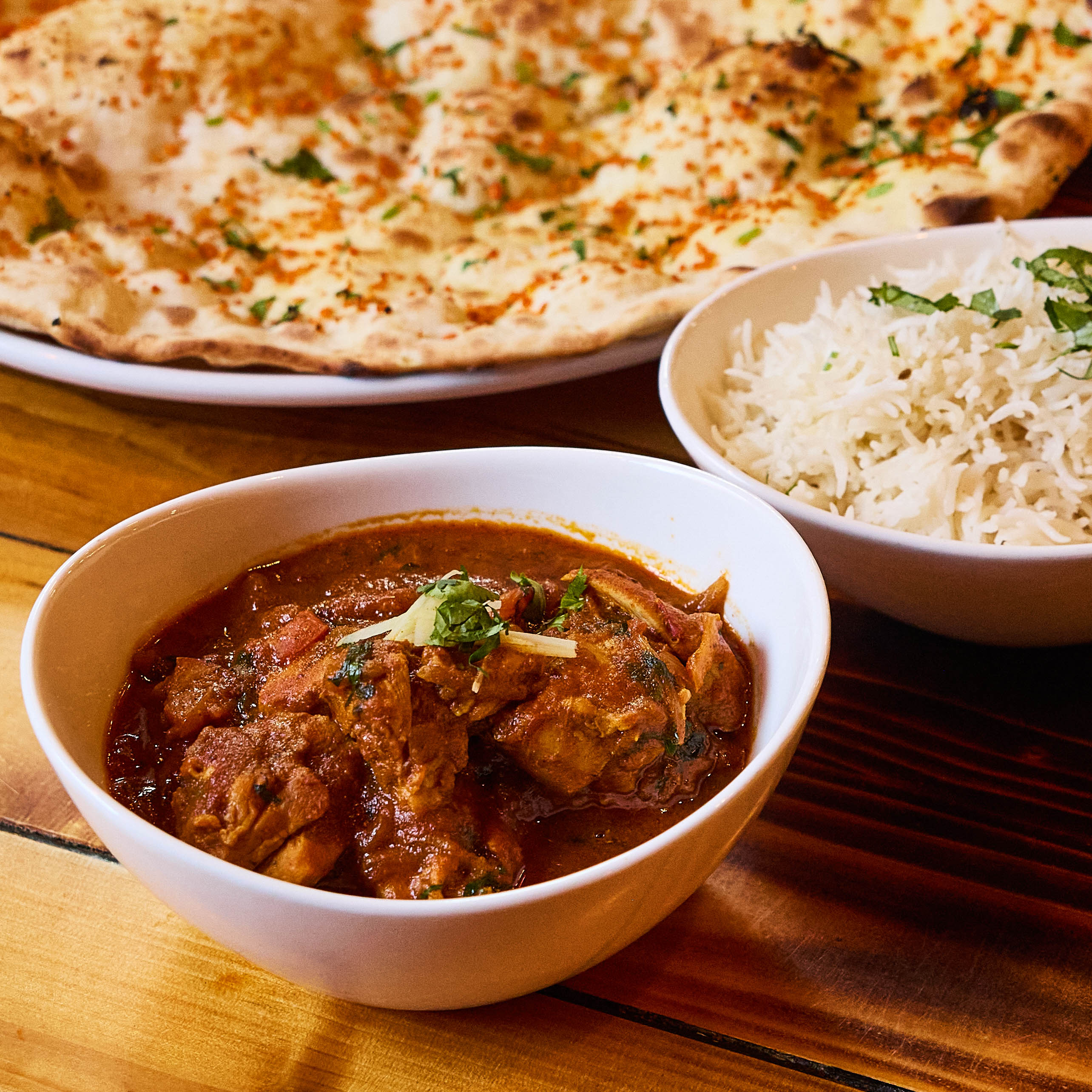 Chicken karahi served with rice and naan on the side