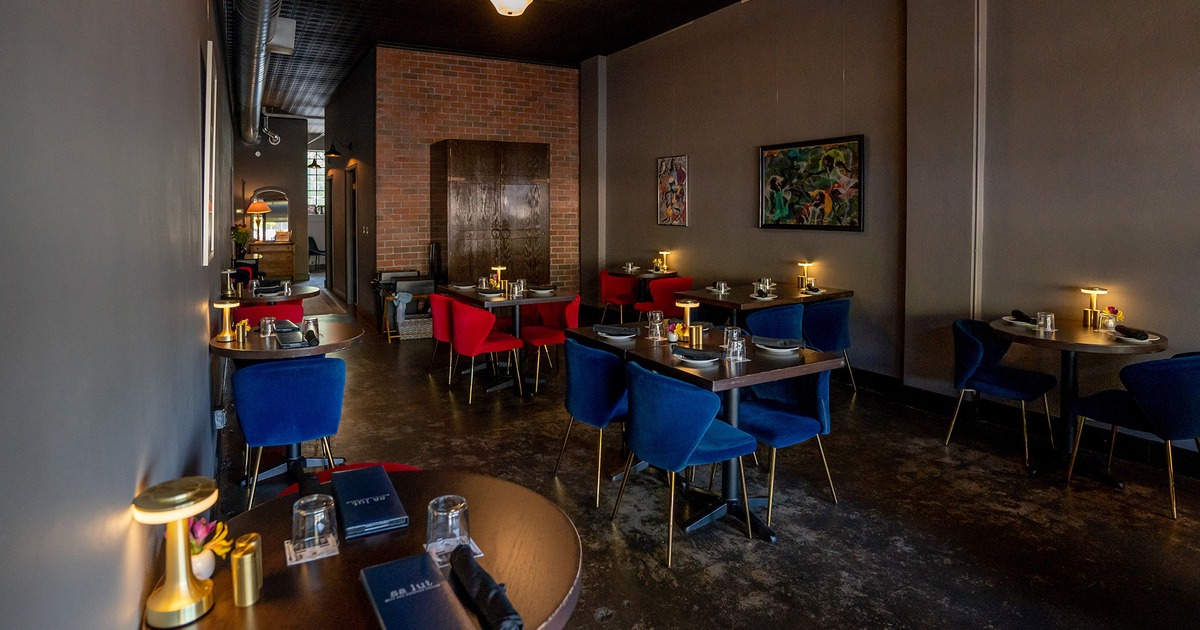 Restaurant interior, dining area with set up dining tables and upholstered chairs