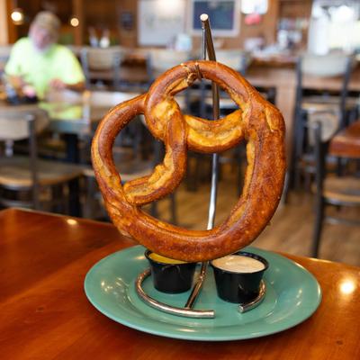 Large soft pretzel served with dipping sauces.