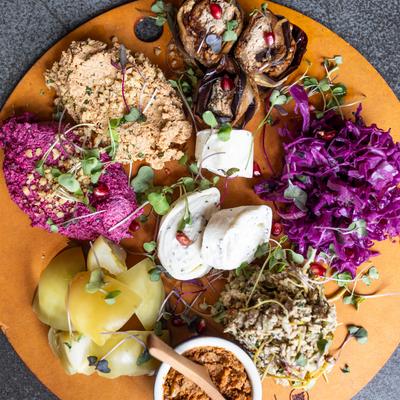 Round wooden platter with assortment of colorful Georgian starters.