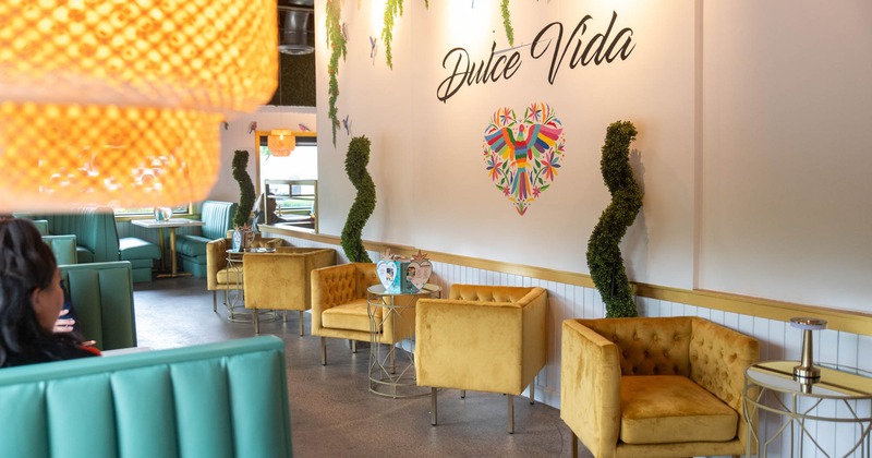 Decorated wall, logo, armchairs and tables for 2 in front