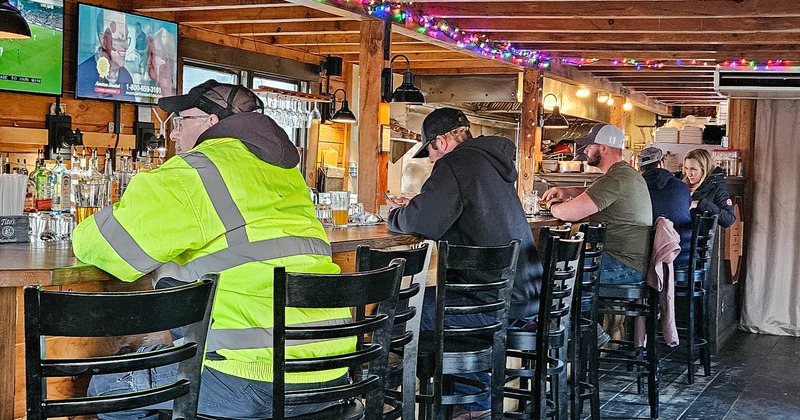 Interior, bar area, guests sitting at the bar