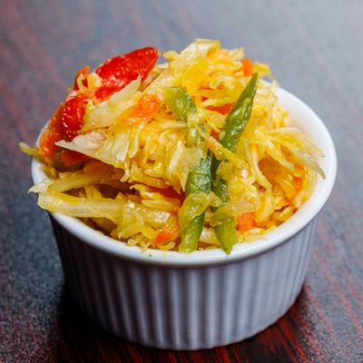 Spicy pickled vegetables in a white ramekin.