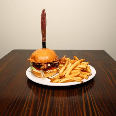 Bacon cheeseburger with French fries.