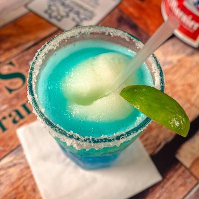 Cowboy Margarita served in saly-rimmed glass with a lime wedge garnish.