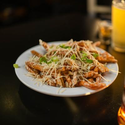 Rosemary Garlic Parmesan Fries topped with scallions.