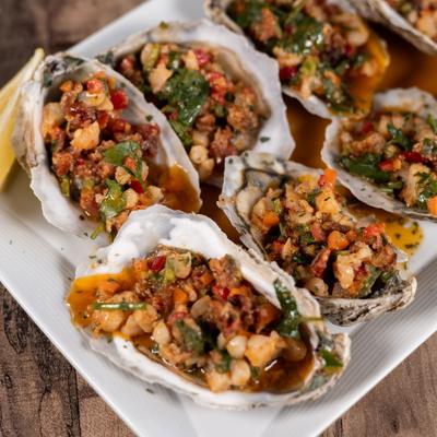Steamed Oysters topped with diced savory mixture.