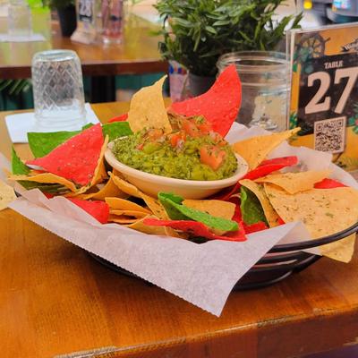 Guacamole dip with colored tortilla chips