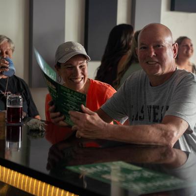 Customers sitting at the bar.