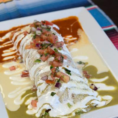 Burrito with pico de gallo, white queso, green sauce, and red enchilada sauce.