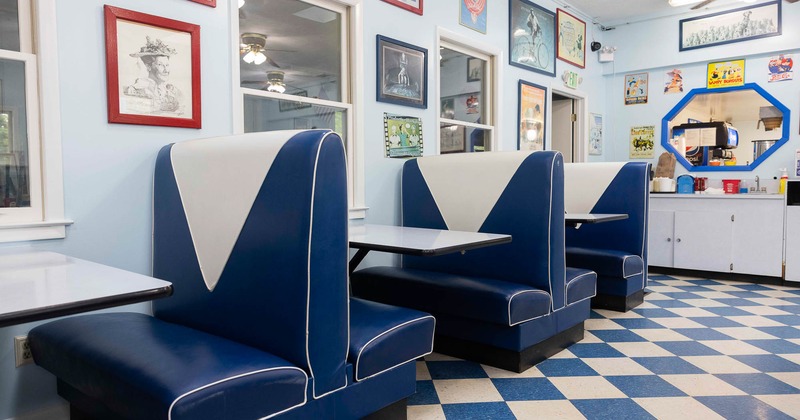 Interior, dining booths near wall with pictures