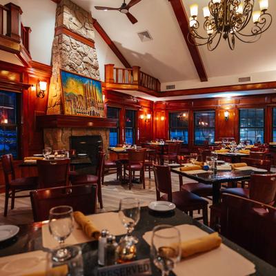 Seating room with set tables and chairs, ready to receive guests.