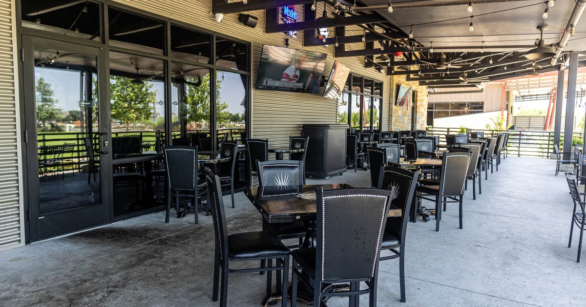 Exterior, table, chairs and TV on the wall