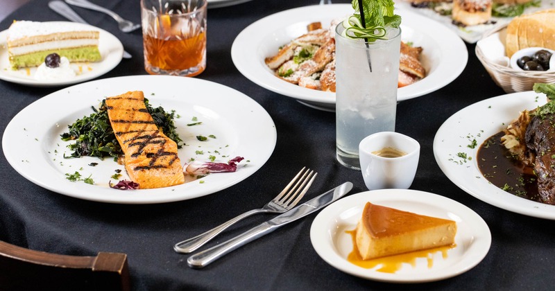 A variety of gourmet dishes and drinks set on a dining table