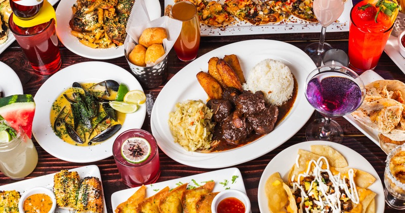 An assortment of dishes and cocktails arranged on a table, top view