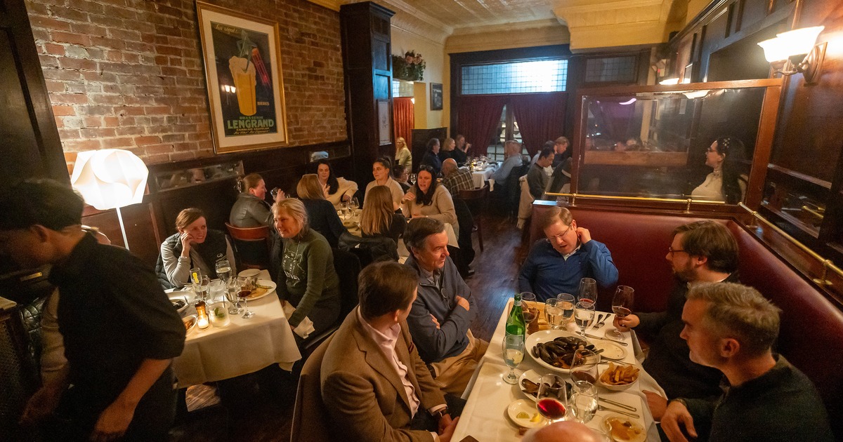 Cozy interior dining area full of guests chatting and enjoying their food and drinks