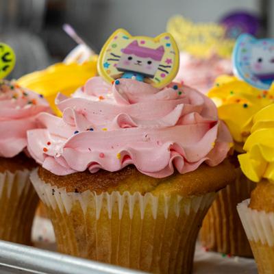 Muffins with pink and yellow frosting.