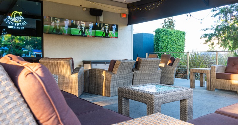 Interior, tables and chairs lined up, buttoned brown leather seating