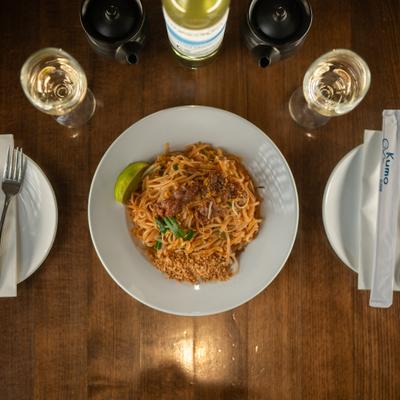 Pad Thai noodles served with white wine.