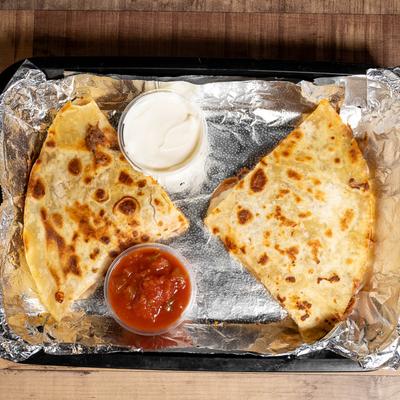 Quesadillas served with two dips, top view.