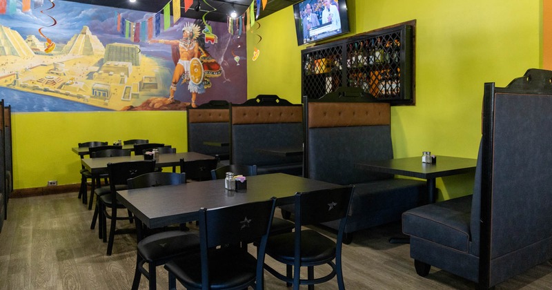 Interior, seating area, closed drink rack and TV on a wall, mural on the wall on the left