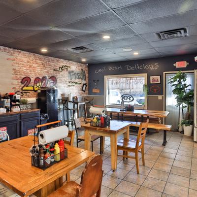 Interior with wooden tables, chairs and self-service counter.