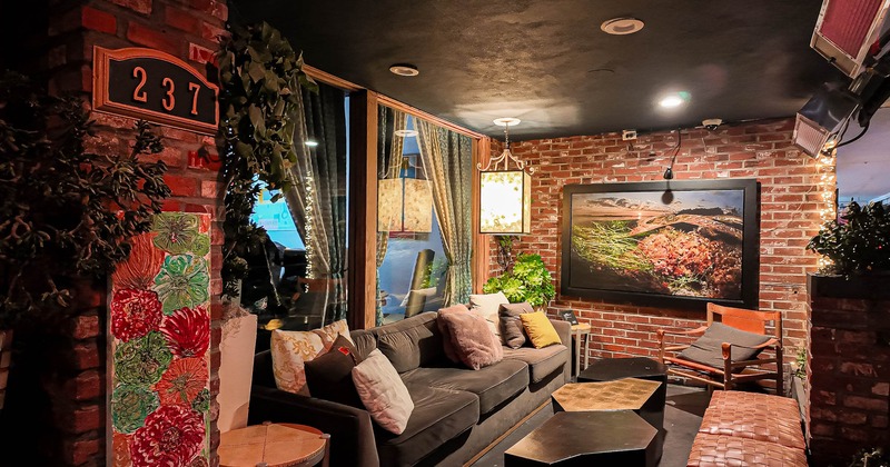 Interior, lounge area, comfortable sofa with armchair and coffee tables, various decor