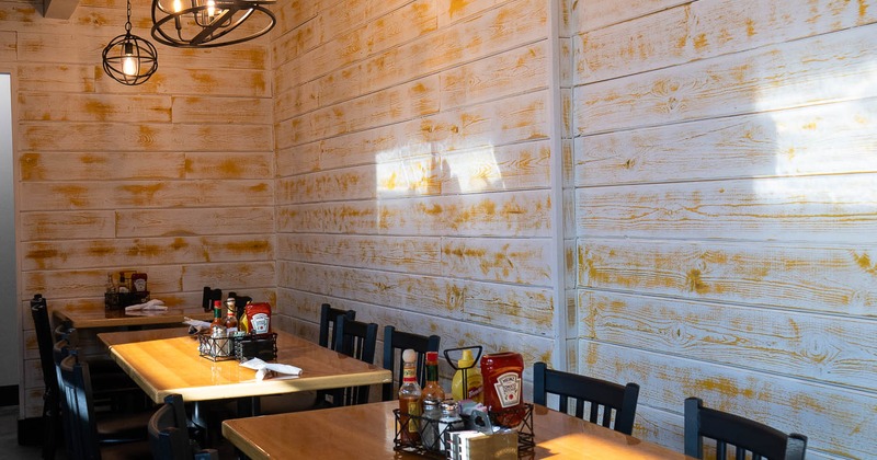 Interior, tables and chairs near wall