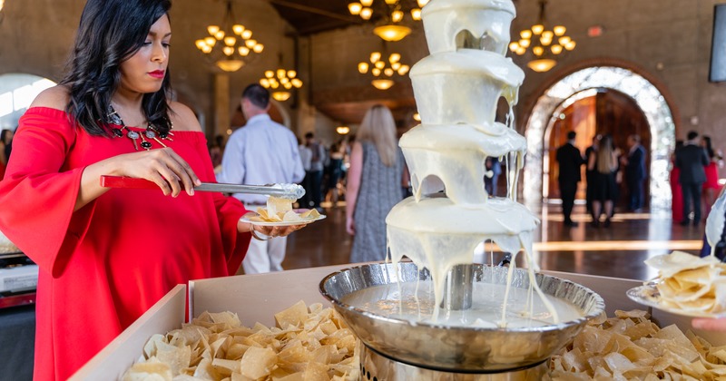 Interior, guest taking chips from dressing fountain