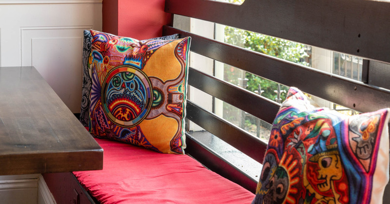 Interior, bench and pillows with mexican art covers