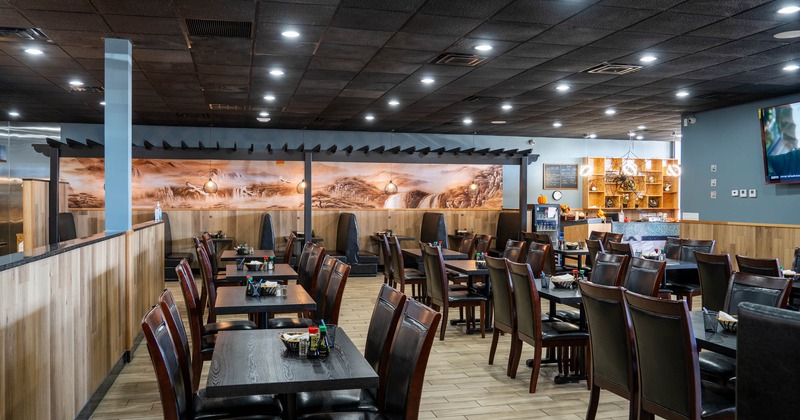 Interior, dining area, tables and chairs ready for guests, condiments on the table