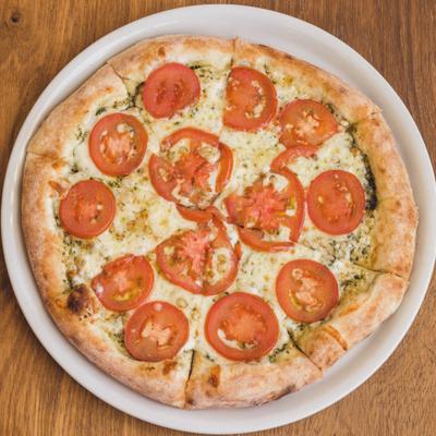 Margherita pizza served on a wooden table.