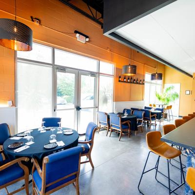 Interior, dining room with place settings on tables.