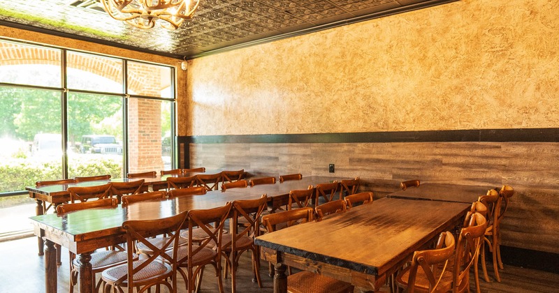 Interior featuring lots of natural light, long tables with chairs