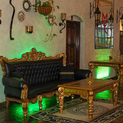 Interior with Baroque furniture including sofa, tables and decorations.