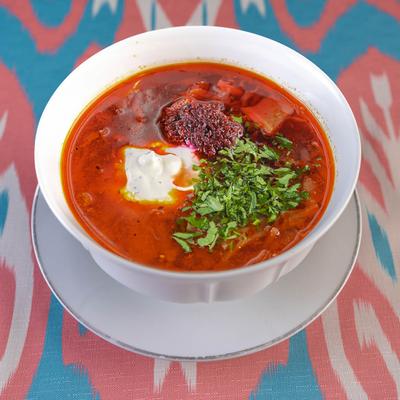 Beet soup with beef, cabbage, carrots, potatoes, and sour cream.