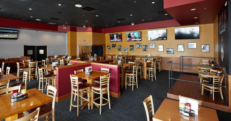 Interior, dining area, tables and chairs, TVs on the walls
