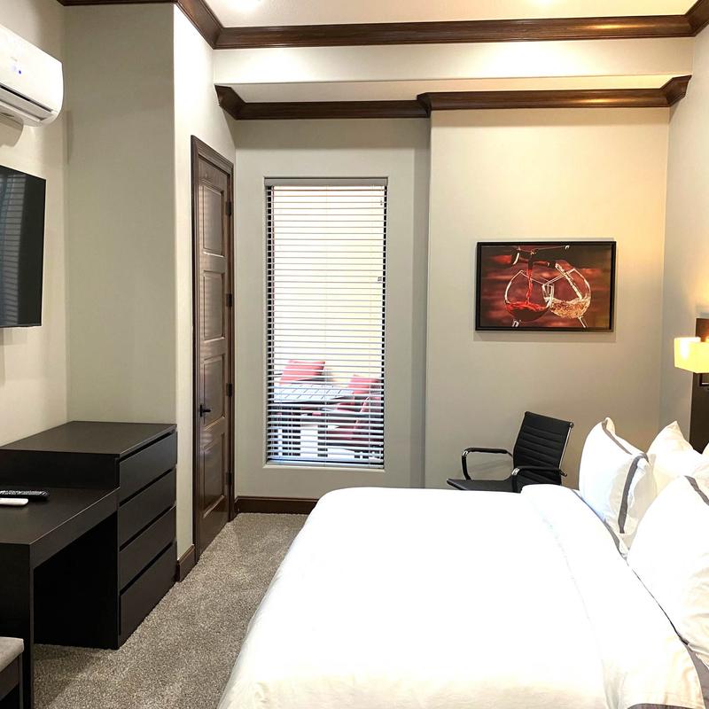 A large couple's bed and other furniture in the bedroom.