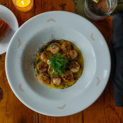 Plate of seared scallops.