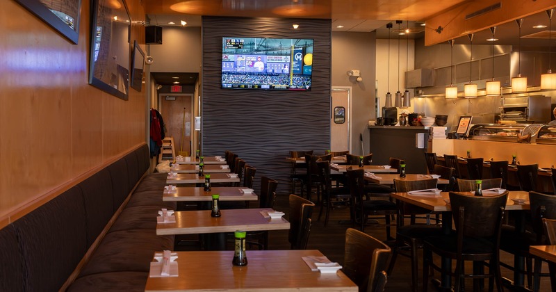 Diner area, tables in line, tv screen above